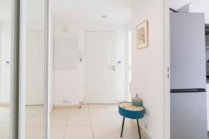 a kitchen with a blue stool and a refrigerator at Plaza Antibes one bedroom apartment with AC in Antibes