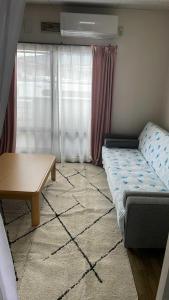 a living room with a couch and a table at Tsukimisou guest house in Tsuru 
