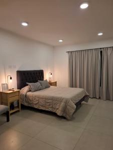 Postel nebo postele na pokoji v ubytování Departamentos del Trébol II