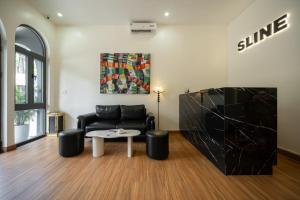 a living room with a couch and a table at Sline Hotel in Hue