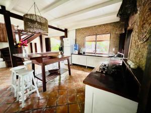 a kitchen with a table and a counter top at Casa do Boi, charming house ideally located in Atins ! in Atins +71 photos