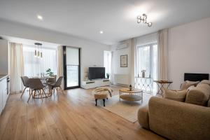 a living room with a couch and a table at UpHome Suites in Bucharest
