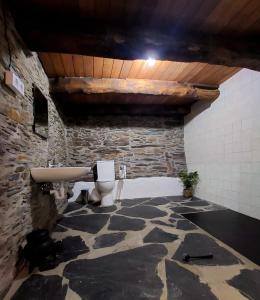 a stone bathroom with a sink and a toilet at As Casias d'Oscos in Villanueva de Oscos +67 photos