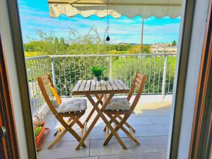 a table and chairs on a balcony with a view at Little Home Vicenza Est in Vicenza +4 photos