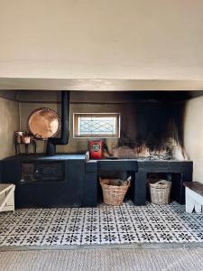 a kitchen with baskets on the floor and a window at Die Tabakhuis - Karoo (Sutherland) in Sutherland +25 photos