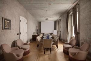 a dining room with a table and chairs and a white screen at Adahan DeCamondo Pera, Autograph Collection in Istanbul