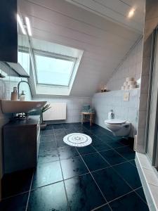 a bathroom with a sink and a toilet at sleepWELL-Metelen - Ausblick & Sehr Modern in Metelen