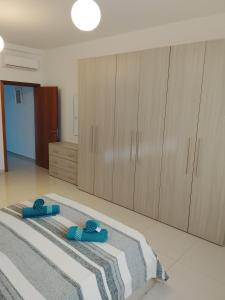 a bedroom with a bed and wooden cabinets at Sorrento in St. Julianʼs