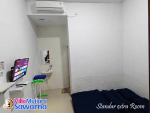 Postel nebo postele na pokoji v ubytování Villa Mutiara Sawarna