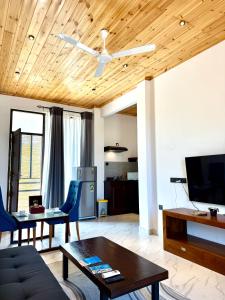 a living room with a couch and a table at Clear Point Studio in Dickwella