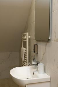 a bathroom with a white sink and a mirror at Перлина Лумшор in Lumshory +58 photos