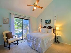 a bedroom with a bed with a ceiling fan and a window at Donna`s Escape in Tybee Island +27 photos