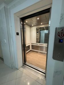 a glass door leading into a room with a mirror at Luxury Ocean Reserve Condo Pool, Gym & Beach Access in Sunny Isles Beach