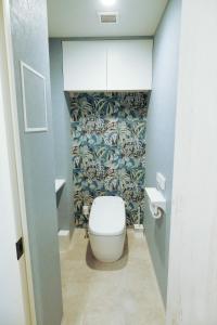 a bathroom with a toilet and a blue wall at Stadt Leben東北ゲートウェイI in Sendai +27 photos
