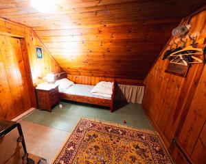 a small room with a bed in a wooden cabin at Almhütte am Seeberg in Brandhof
