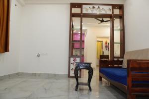 a bedroom with a bed and a mirror and a chair at svhotel in Tirupati