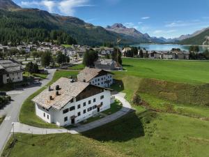 an aerial view of a village with a lake and mountains at Apartment Chesa Linaria by Interhome in Surlej