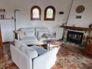a living room with two couches and a fireplace at Holiday Home Zindel by Interhome in Balcon del Mar +23 photos