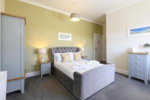 a bedroom with a large bed in a room at Sure Hotel Collection by Best Western Porth Veor Manor Hotel in Newquay