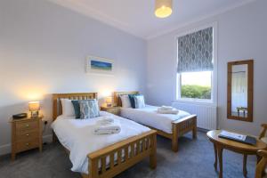 a bedroom with two beds and a window at Sure Hotel Collection by Best Western Porth Veor Manor Hotel in Newquay +132 photos