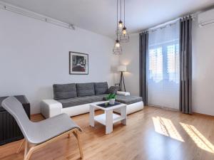 a living room with a couch and a table at Apartment Katarina-1 by Interhome in Rabac