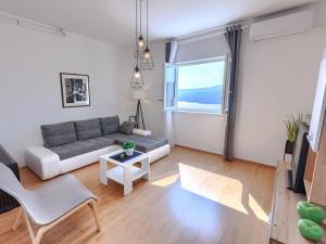 a living room with a couch and a window at Apartment Katarina-1 by Interhome in Rabac +32 photos