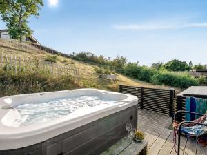 a bath tub sitting on top of a deck at Holiday Home Eila - 400m from the sea by Interhome in Glesborg