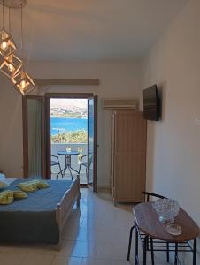a bedroom with a bed and a view of the ocean at Akrogiali Rooms & Studios in Drymonas +53 photos