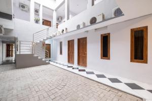 a hallway of a house with a checkered floor at Hotel O Near Tugu Yogyakarta 1 formerly Crown Residence in Jetis