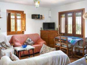 a living room with a couch and a tv at Holiday Home El Cerrillo - Cerro Negro by Interhome in Órgiva