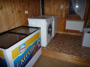 a washer and dryer in a room at Chalet La Marmotte 1800m in Ollon