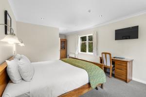 Giường trong phòng chung tại Ngati Ruanui Stratford Mountain House