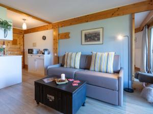 a living room with a couch and a table at Studio Le Bristol A25-31 by Interhome in Villars-sur-Ollon