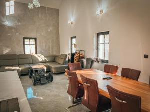a living room with a table and a couch at Holiday Home Party & Friends Villa by Interhome 