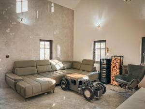 a living room with a couch and a car on it at Holiday Home Party & Friends Villa by Interhome 