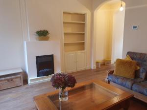 a living room with a coffee table and a fireplace at Aan de Waterspiegel in Aagtekerke