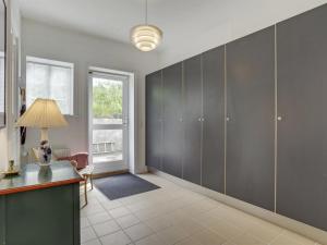 a home office with gray cabinets and a lamp at Apartment Delfina - 250m from the sea by Interhome in Hjørring