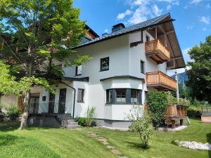 uma casa branca com varandas e um quintal em Appartement Carl em Seefeld in Tirol