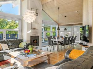 a living room with a couch and a table at Holiday Home Mechthild - 2-7km from the sea by Interhome in Saltum +18 photos