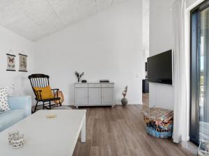 a white living room with a couch and a table at Holiday Home Cresta - 1-4km from the sea by Interhome in Løkken