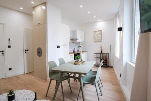 a kitchen and dining room with a table and chairs at Le Chenavard I-hyper centre-Central air conditioning in Lyon +10 photos