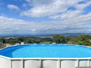 a swimming pool with a view of the mountains at Apartment Bellavista-1 by Interhome in Castellina Marittima