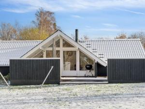 a house with a window and a grill in front of it at Holiday Home Janik - 1-3km from the sea by Interhome in Græsted +31 photos