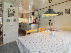 a kitchen and a table with a white table cloth at Holiday Home Thorfrid - 1km from the sea by Interhome in Sønderho