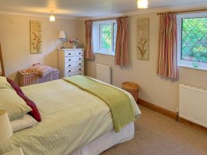 Postel nebo postele na pokoji v ubytování Picket Hill Cottage + 9 fotografií