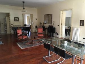 a living room with a glass table and chairs at Attico vista mare in Pescara