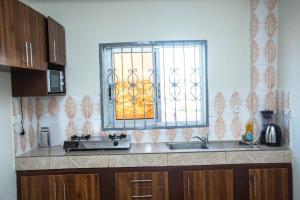 a kitchen with a sink and a window at Yaoundé in Yaoundé