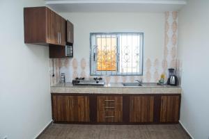 a kitchen with a sink and a window at Yaoundé in Yaoundé