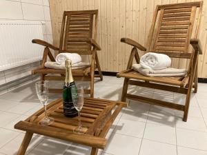 two chairs with a bottle of champagne and two glasses at Hotel Prokopávka in Pilsen