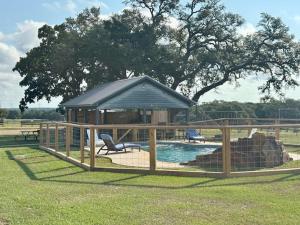 a gazebo with a swimming pool in a field at Astoria in Round Top